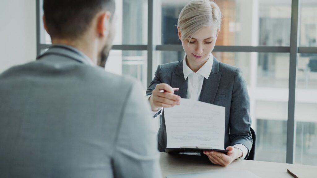 Two professionals reviewing a service agreement in an office