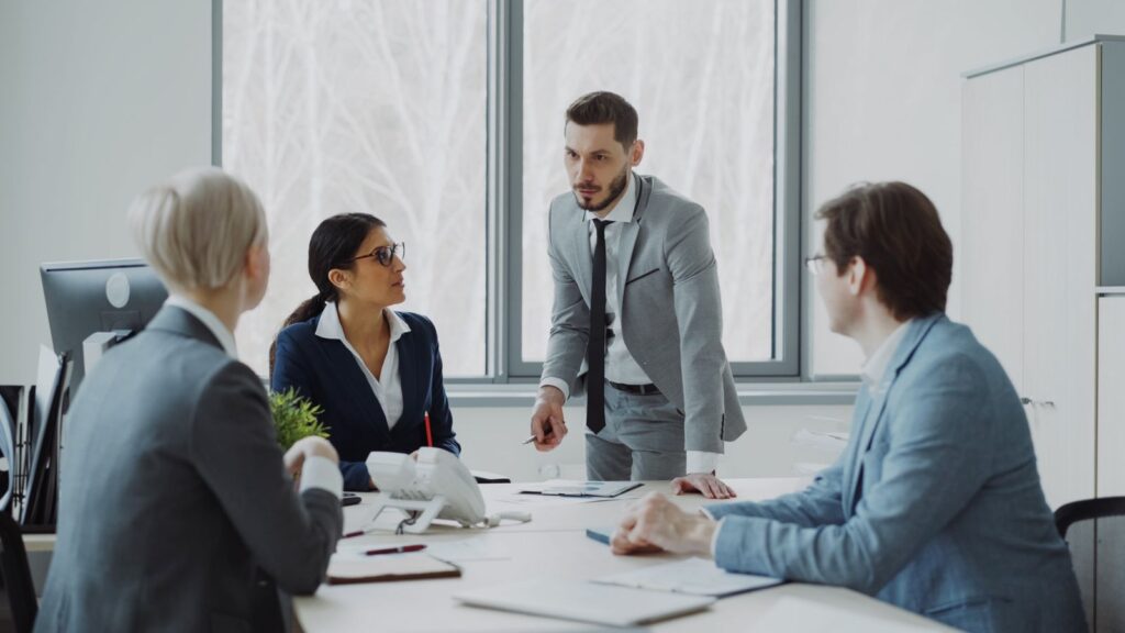 Business advisors meeting around a conference table to review registered agent responsibilities