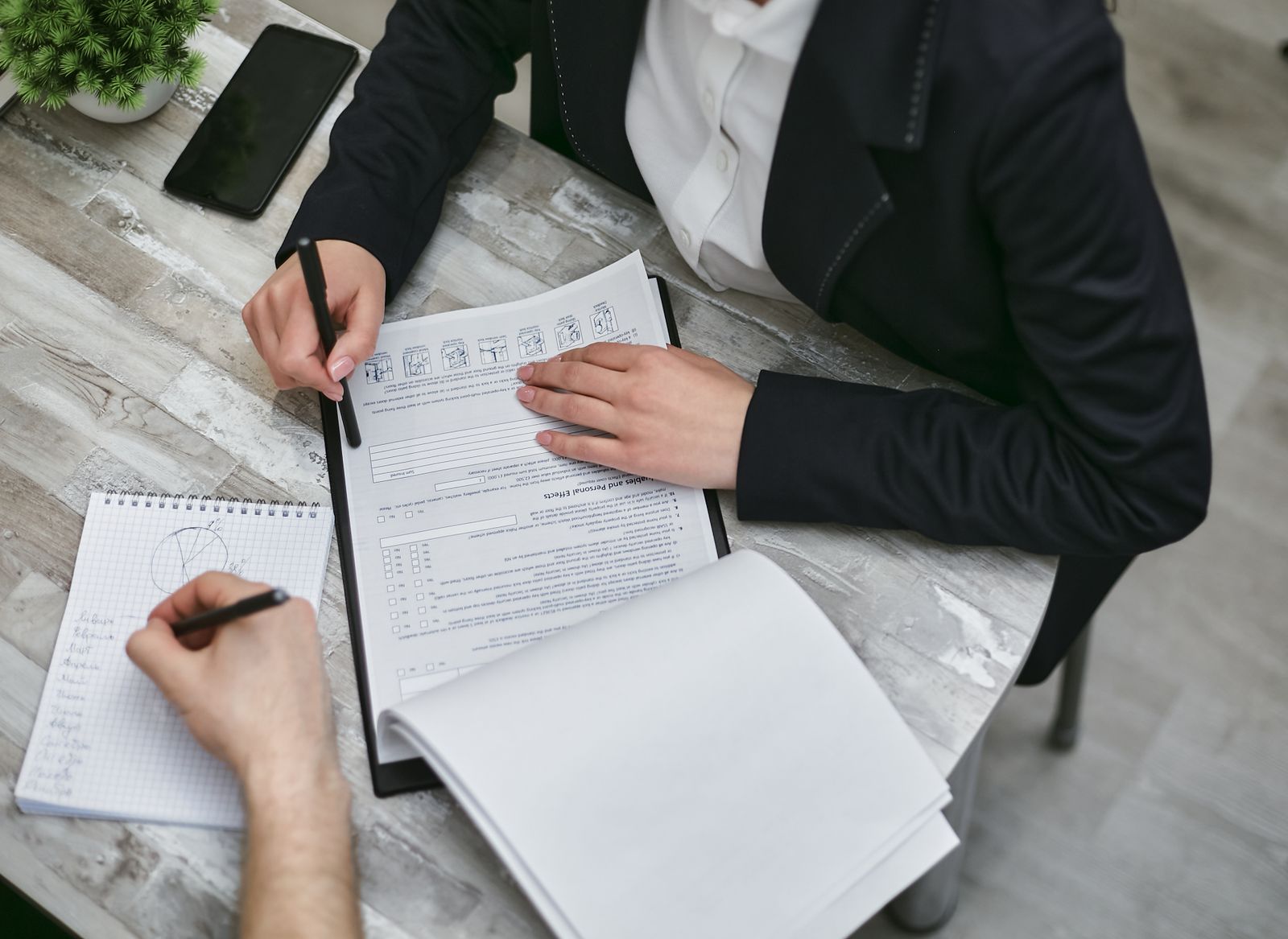 Advisor and business owner reviewing financial documents together at a desk