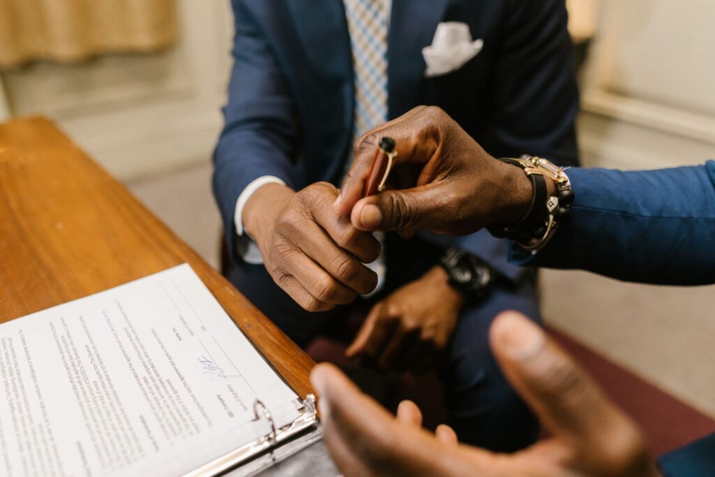 Business owner and worker shaking hands over a signed agreement, the moment the employee vs independent contractor question should already be settled