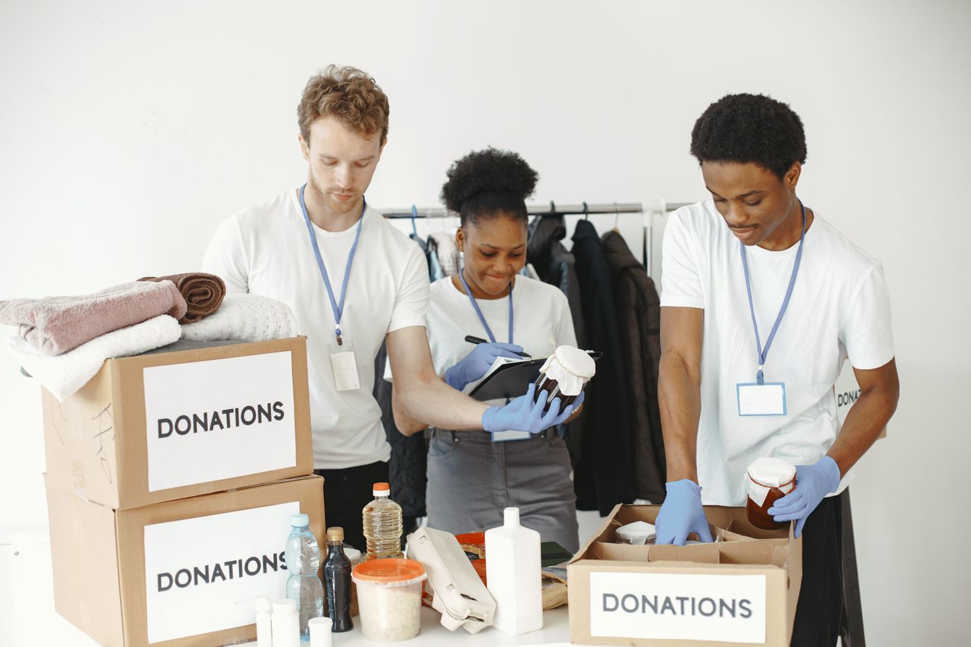 Volunteers organizing donation boxes for a nonprofit program funded by a grant