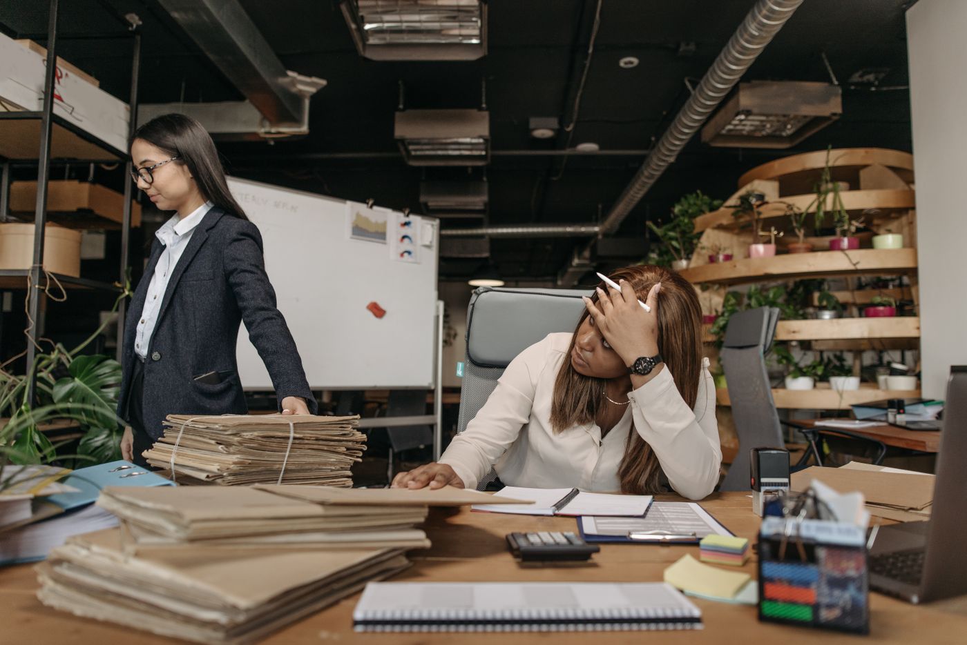 Two office staff working through documents together as part of business admin support